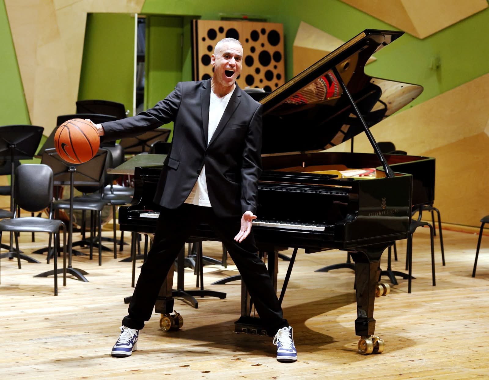 Lay Z Gordon holding a basketball at the grand piano